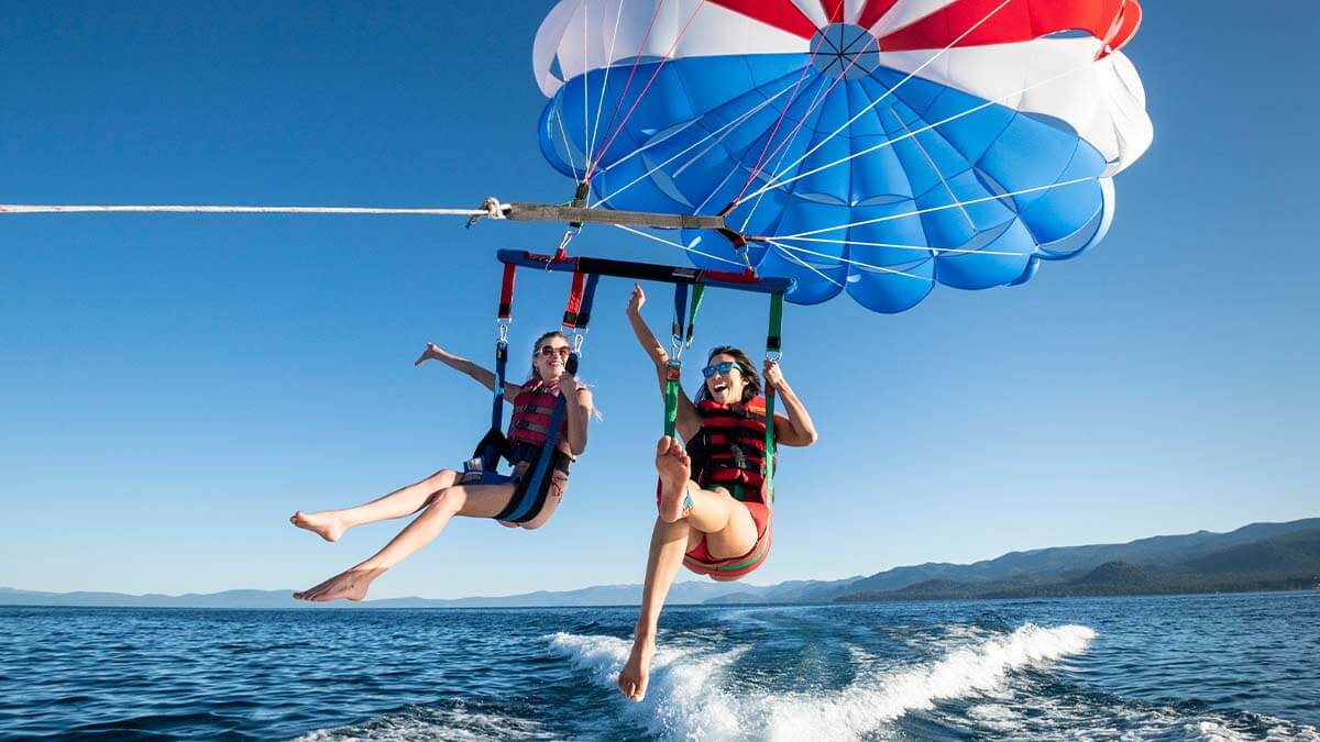 two women parasailing in lake tahoe