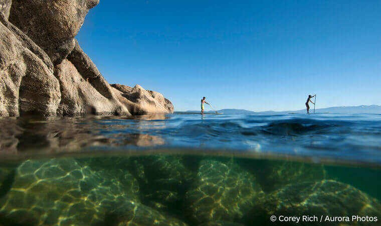 Two stand up paddlers on east shore of Lake Tahoe Water Trail. | (c) Corey Rixh / Aurora Photos
