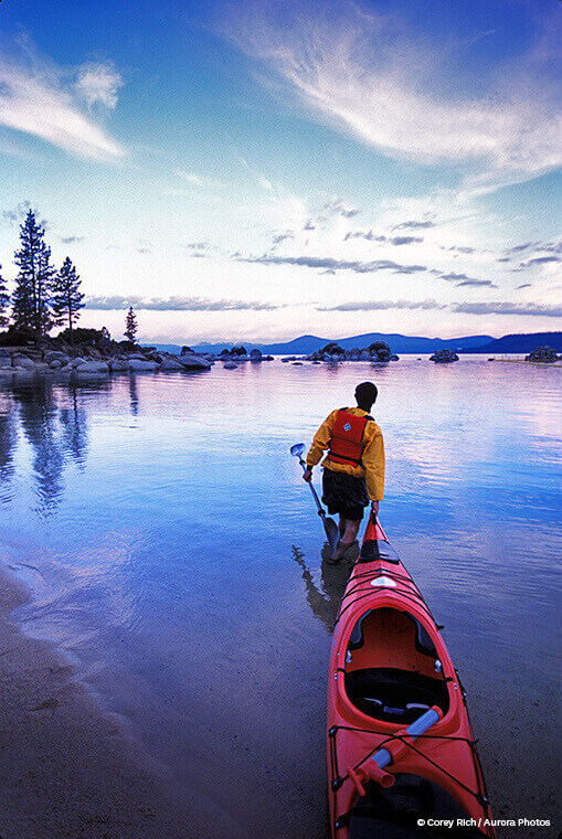 Kayaker at sunset on the Lake Tahoe Water Trail. | (c) Corey Rich / Aurora Photos