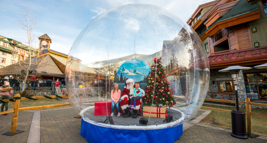 Kids taking photo with Santa in Snowglobe at Heavenly Holidays in South Lake Tahoe