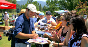 Tony Romo signing autographs at the American Century Golf Tournament