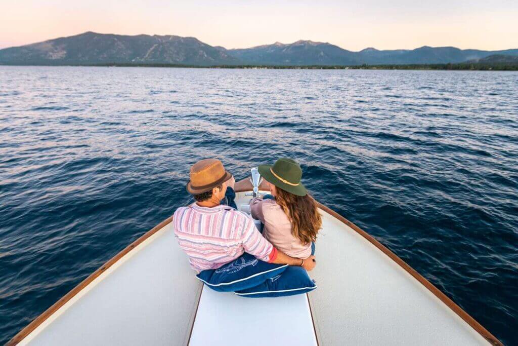 a couple on the bow of a boat on lake tahoe