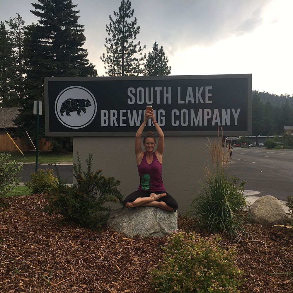 yoga pose in front of South Lake Brewing Company sign