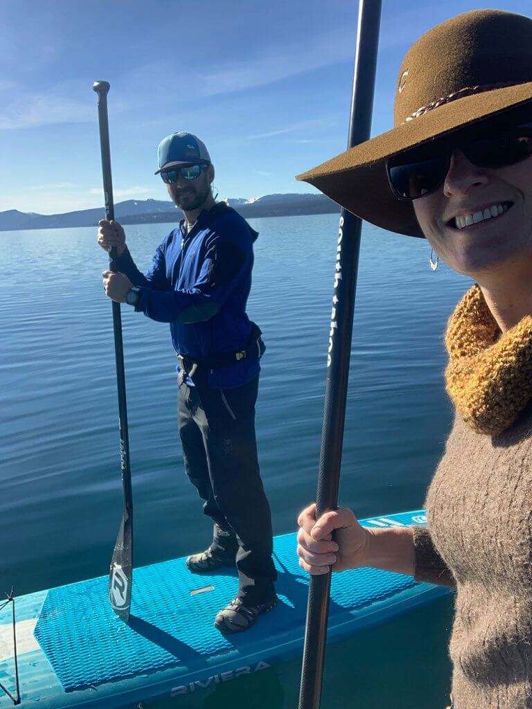 Couple stand up paddle boarding on Lake Tahoe