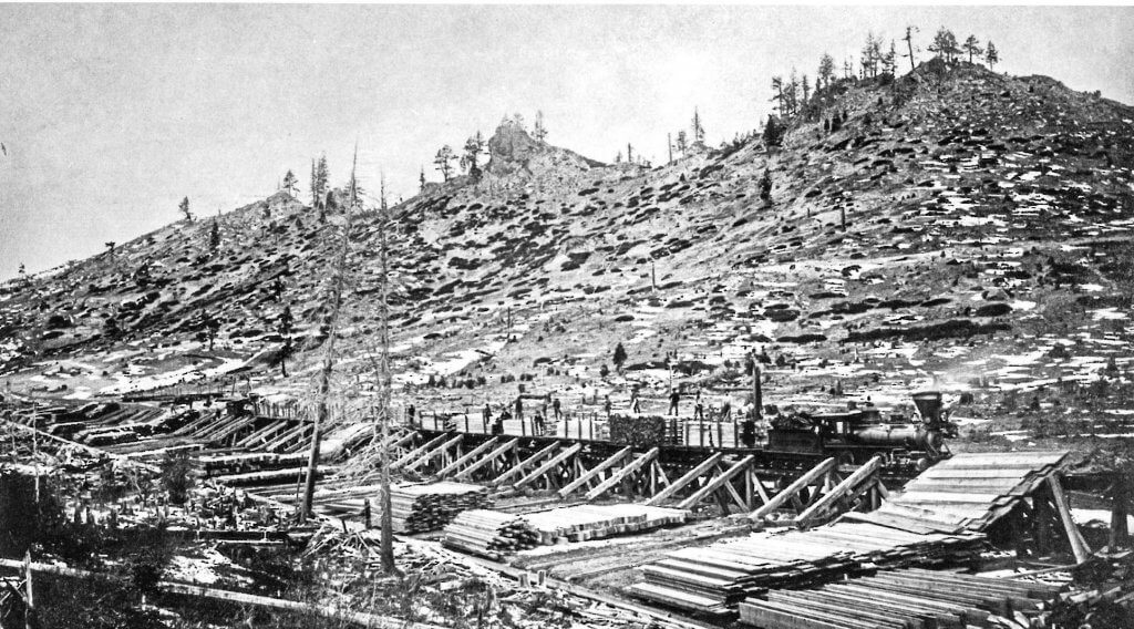 Old time photo - Lumber milled at Glenbrook on the shores of Lake Tahoe is offloaded at Spooner Summit on its way to Nevada