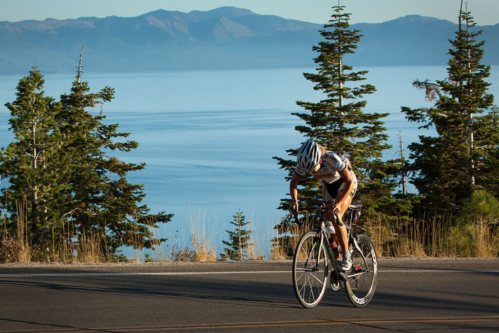 Road Biker riding on the road overlooking Lake Tahoe