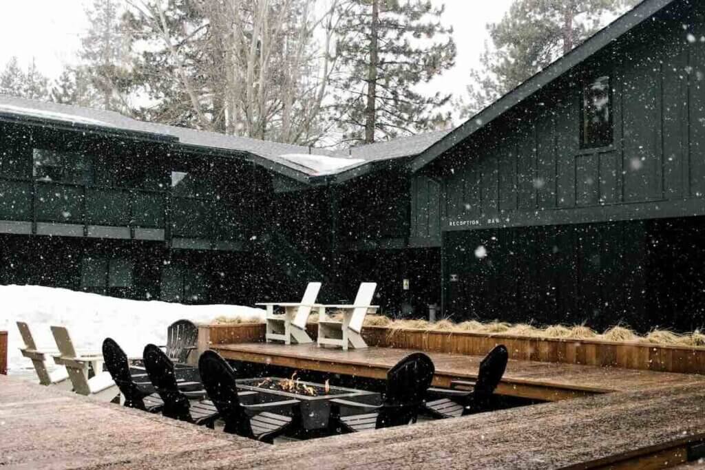 Firepit at Coachman Hotel with snow falling.