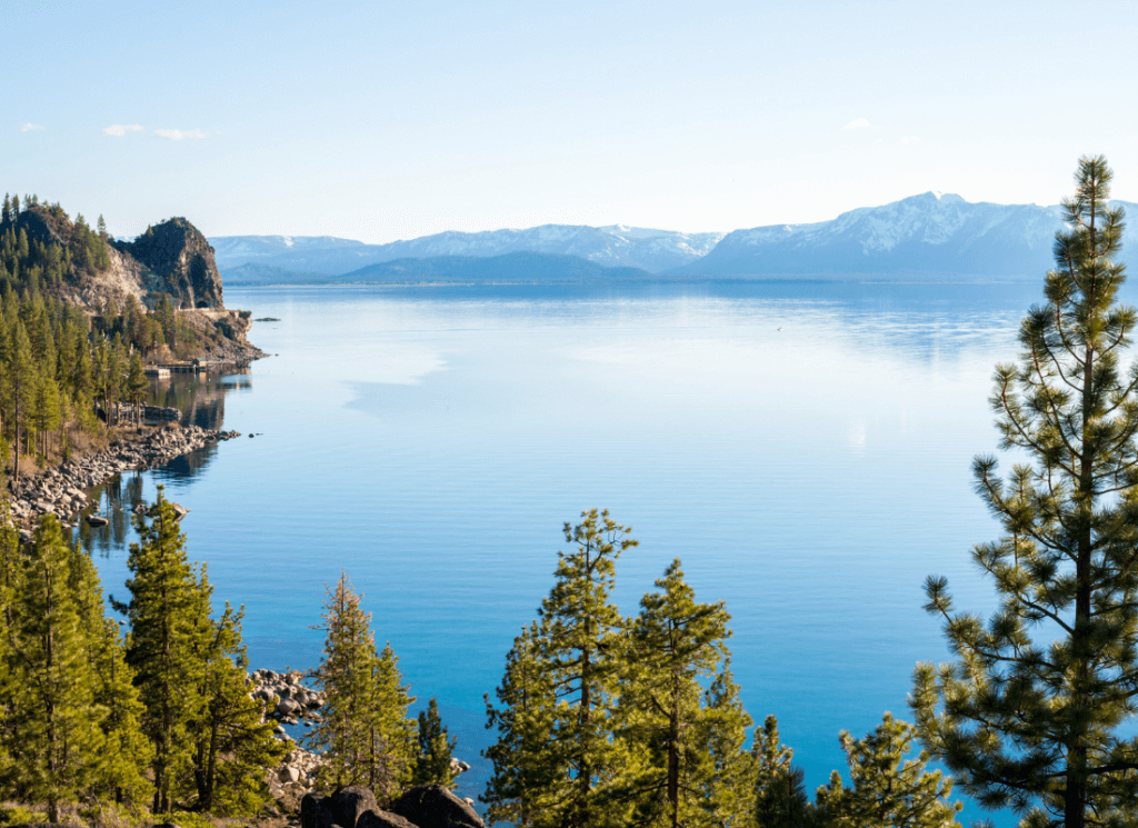 Vista of Lake Tahoe with Mountains and Cave Rock in the distance.