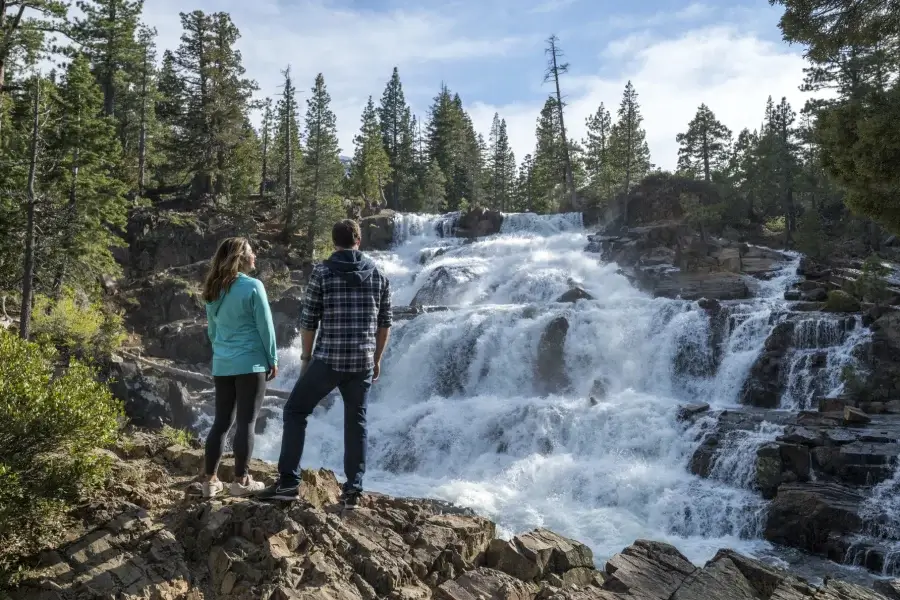 Couple standing in front of a Lake Tahoe waterfall