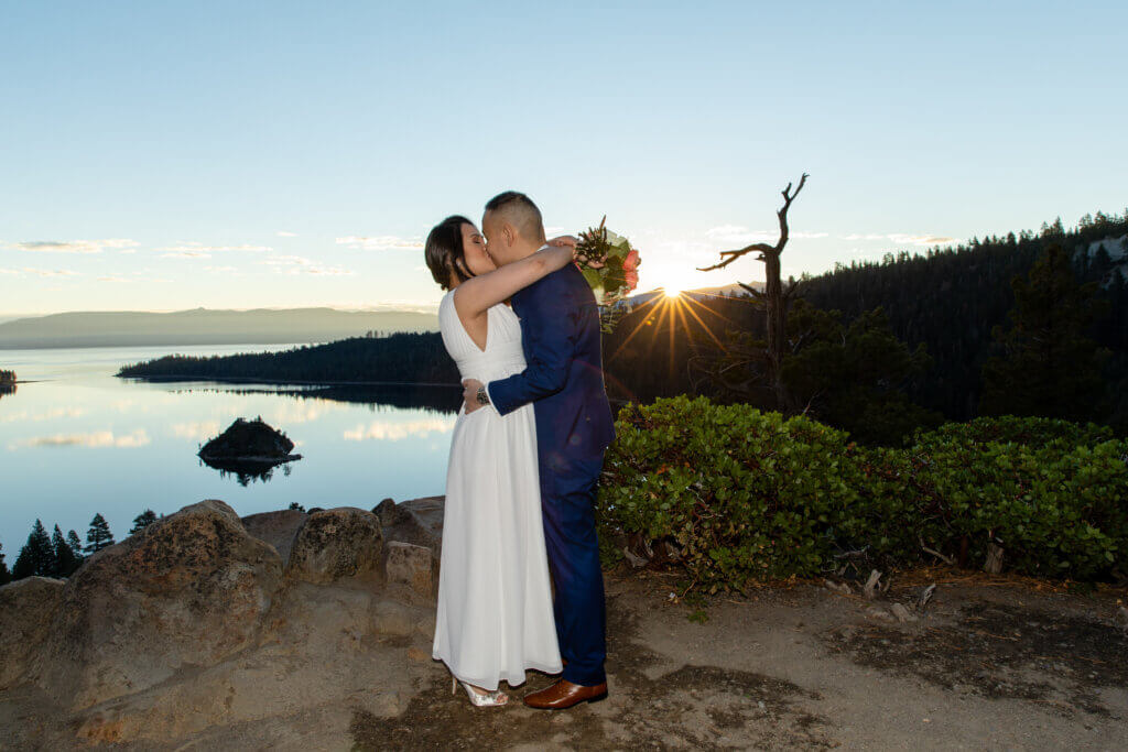 Couple's first kiss as husband & wife at sunrise.