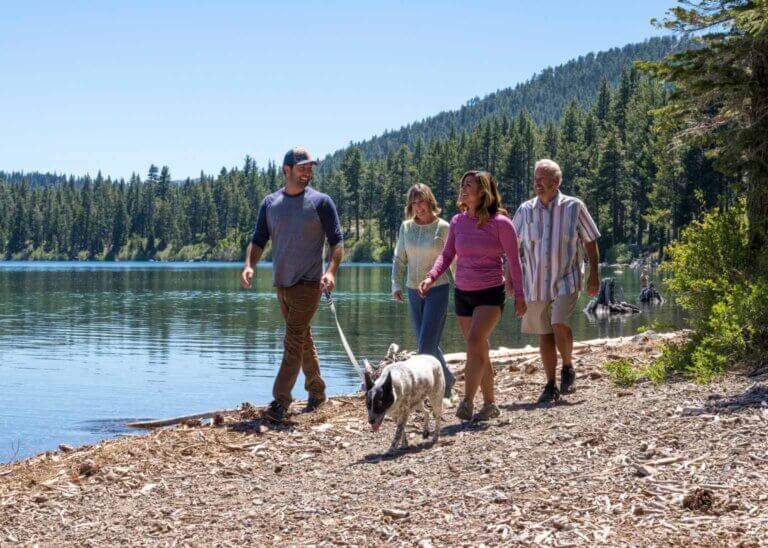 family walking dog lake tahoe beach