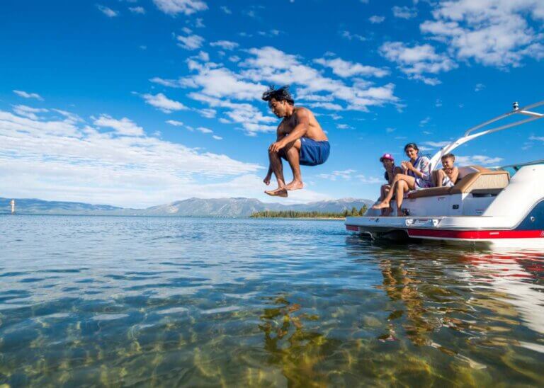 man jumping in lake tahoe