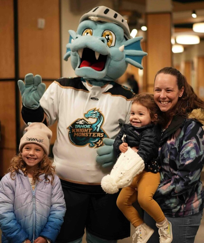 Family poses with Tessie, the Knight Monsters Mascot