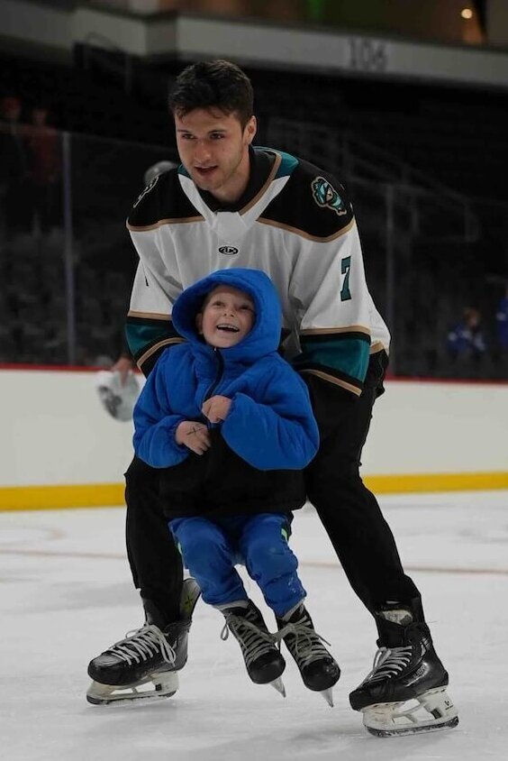 A young fan skates with one of the Knight Monsters.