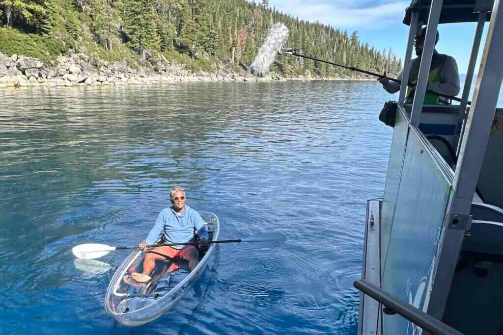 Biju Thomas filming in one of Clearly Tahoe's clear bottom kayaks.