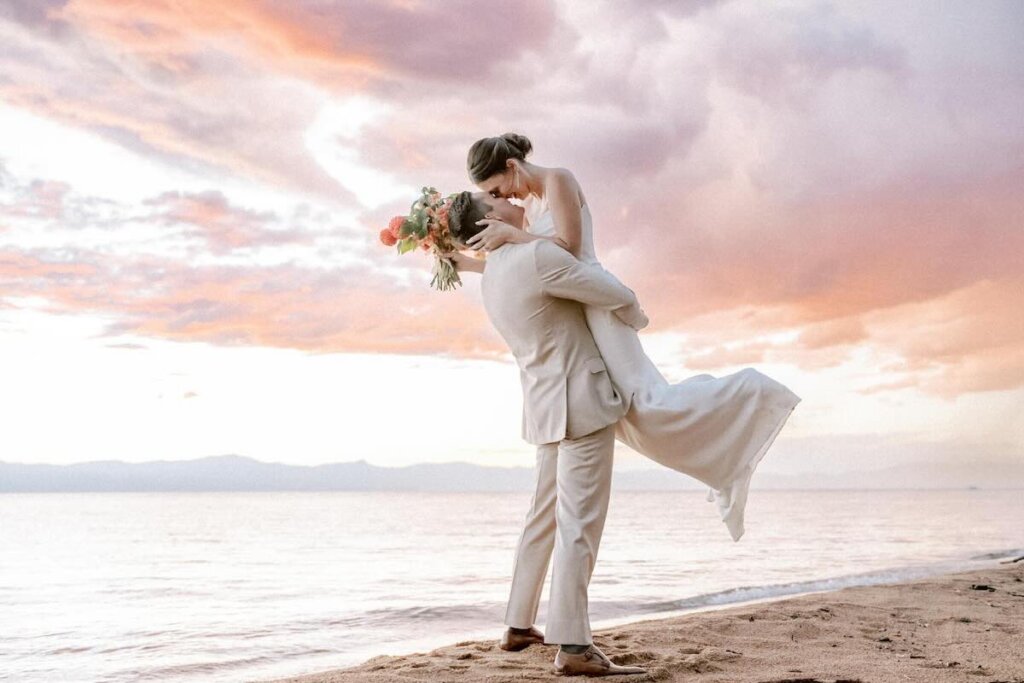 Wedding couple on Lake Tahoe beach at sunset