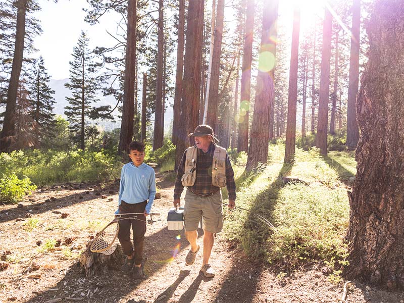 family hiking to lake tahoe fishing spot