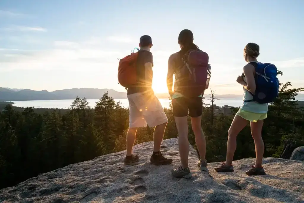 Hikers watching sunset on Lake Tahoe
