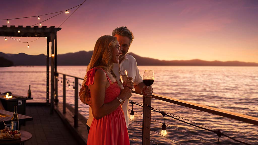couple cocktails with view of lake tahoe at sunset