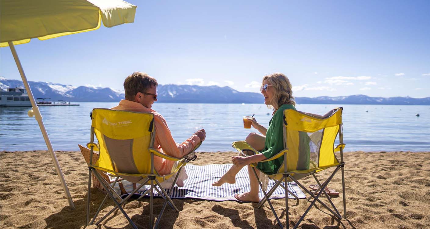 couple enjoying drinks at lake tahoe beach